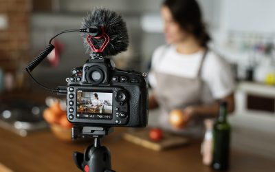 Female vlogger recording cooking related broadcast at home